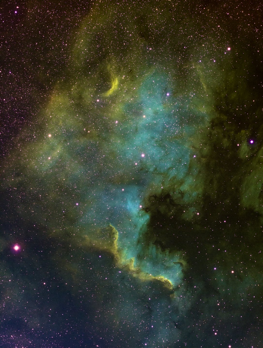 Turquoise and blue nebula with distant stars.